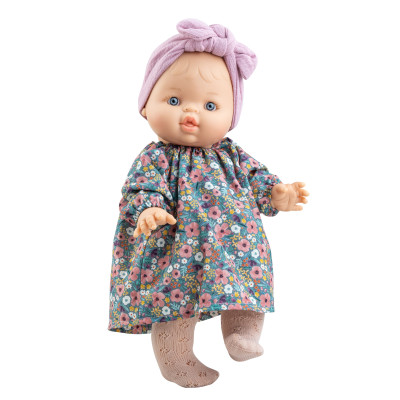 Poupon Gordi Raky 34 cm Paola Reina avec robe fleurie, bandeau mauve et corps en vinyle parfumé à la vanille.